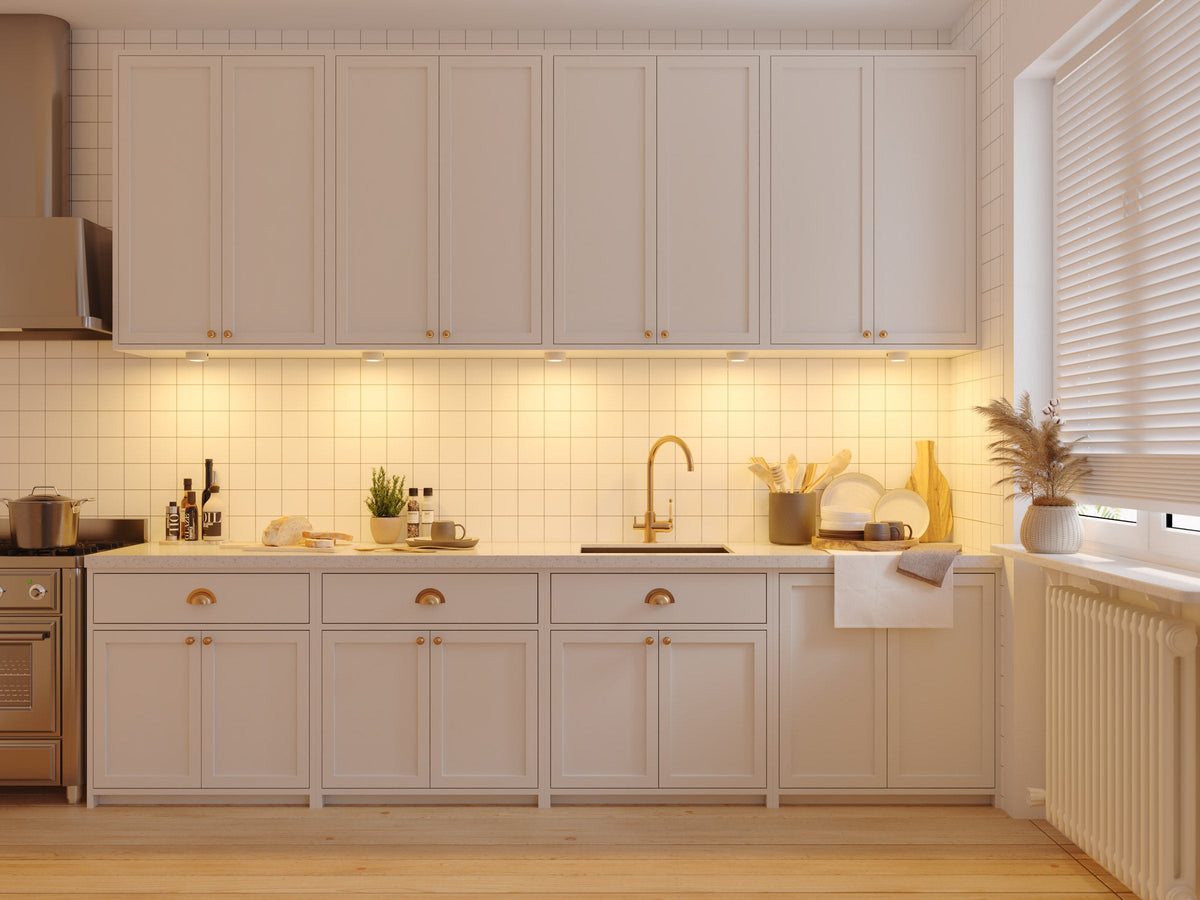 Row of INLIGHT IN-0107 puck lights in 2700K warm white under a run of kitchen cabinets