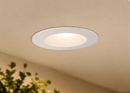 Illustrative round ceiling light in a warm interior from the approved category design; actual fixture and mounting details are shown on product pages.